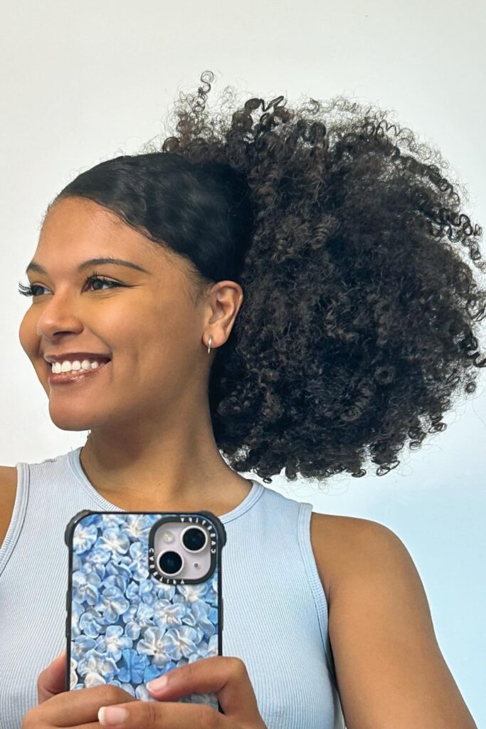 a young woman with a sleek high puff
