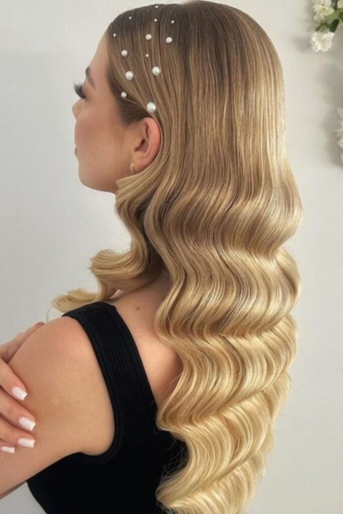 Blonde retro finger waves with small pearl pins scattered across the crown