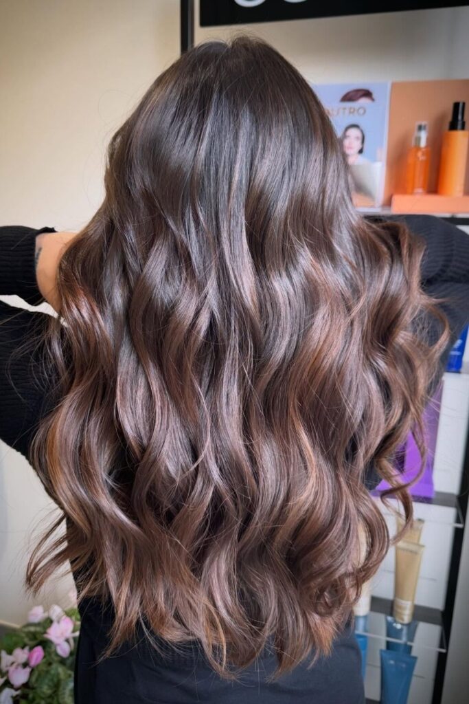 Glossy chocolate brown waves falling past the shoulders, brushed out and shiny