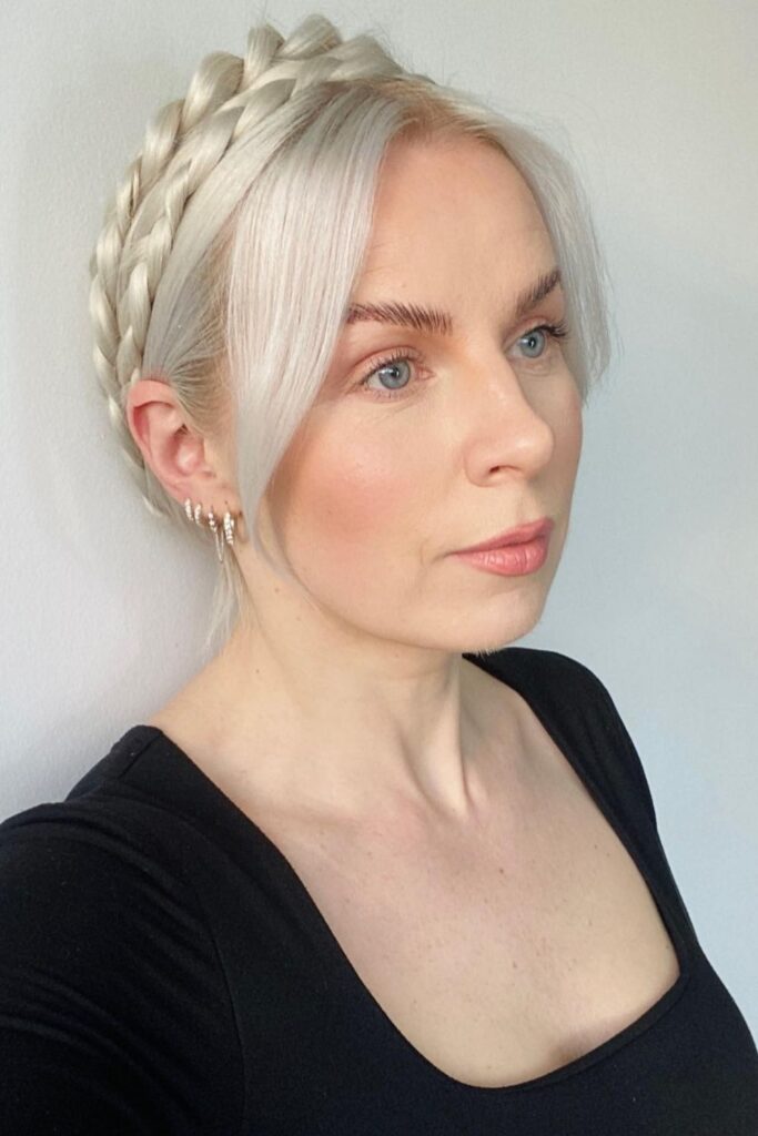 Platinum crown braid wrapped around the head with soft pieces at the front, a must-try a braided hoco hairstyle