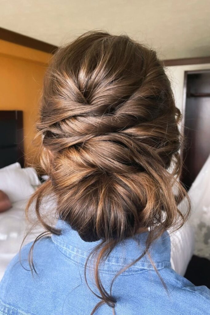 Soft layered twists gathered into a low updo on brown hair