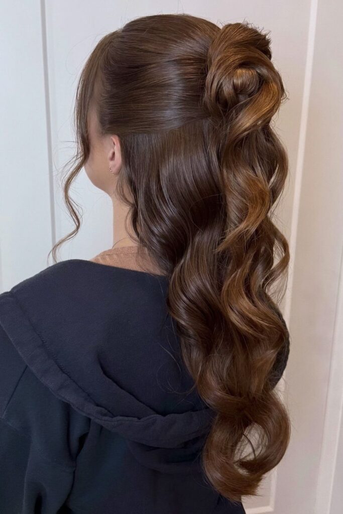 Half-up twist on brunette hair with deep sculpted waves down the back