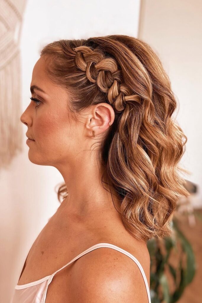 Side braid along the hairline with shoulder-length waves left loose, perfect homecoming hairstyle for medium-length hair