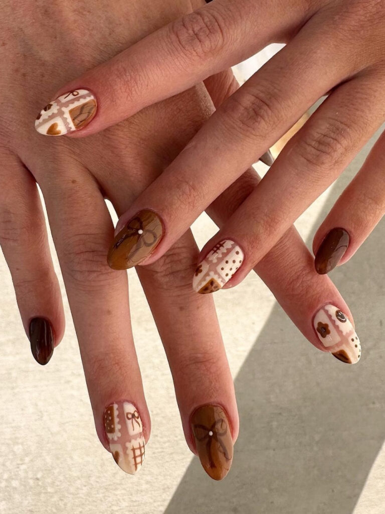 Medium almond nails in glossy chestnut brown alternating with cream patchwork accents featuring bows, hearts, flowers, and gingham squares.