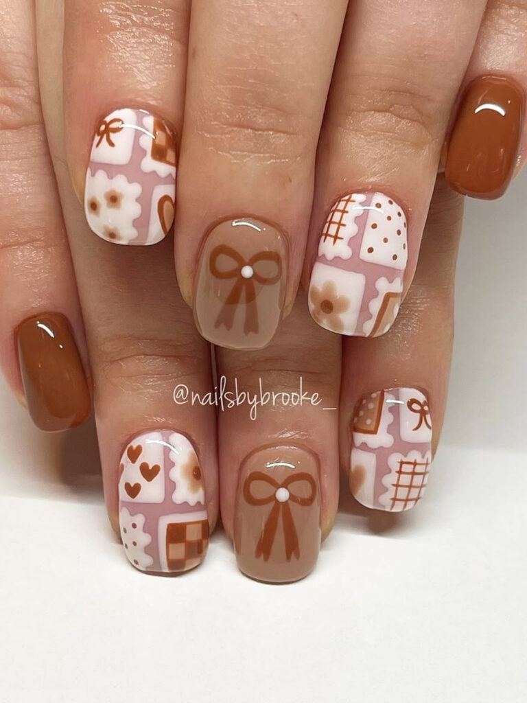 Short square nails in solid rust brown with taupe bow accents and pink patchwork nails featuring hearts, daisies, and checkerboard squares.