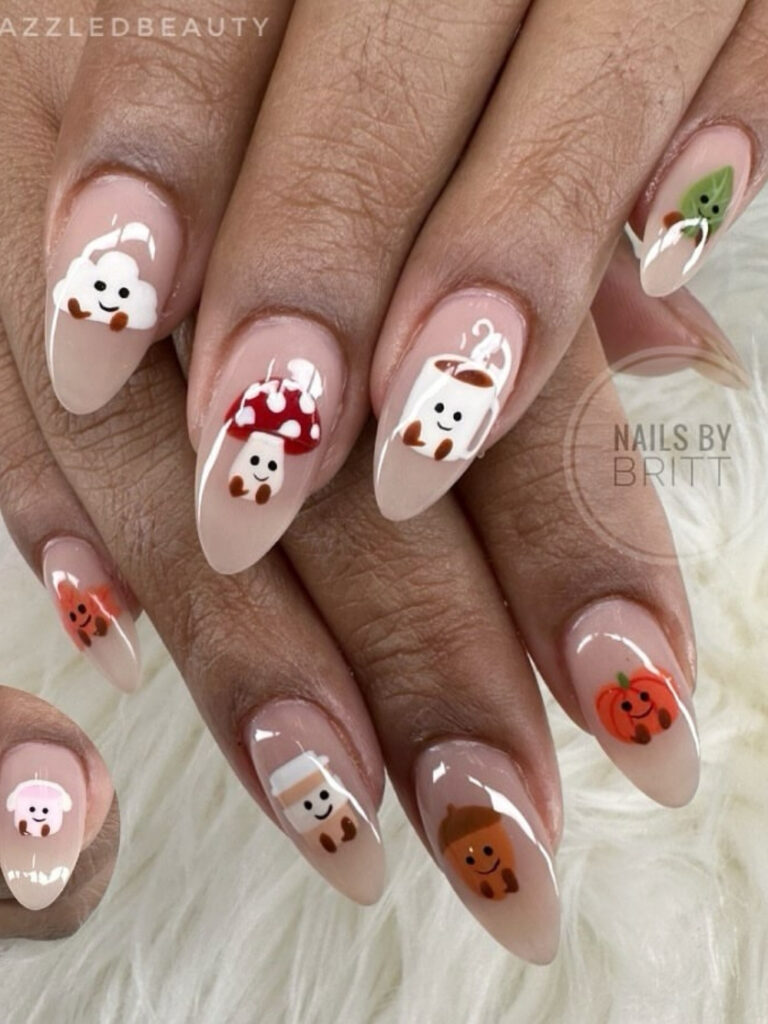 Medium almond nails with nude French tips featuring smiling hand painted marshmallows, mushrooms, coffee cups, acorns, and pumpkins.