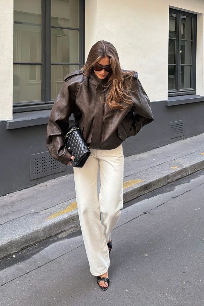 Brown leather jacket with cream wide-leg jeans, a casual fall outfits look