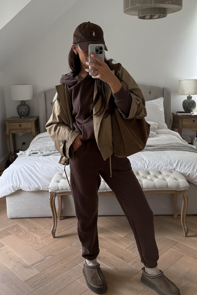 Brown hoodie and matching joggers styled with an oversized khaki jacket, a cozy fall outfits idea