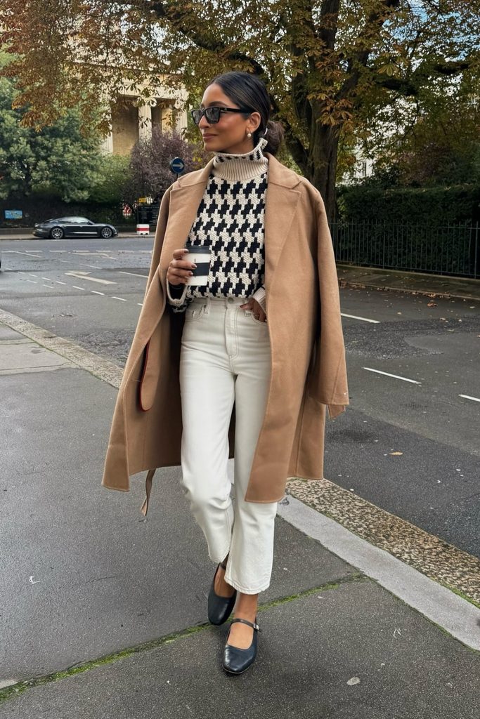 Camel coat with a houndstooth turtleneck sweater and white jeans