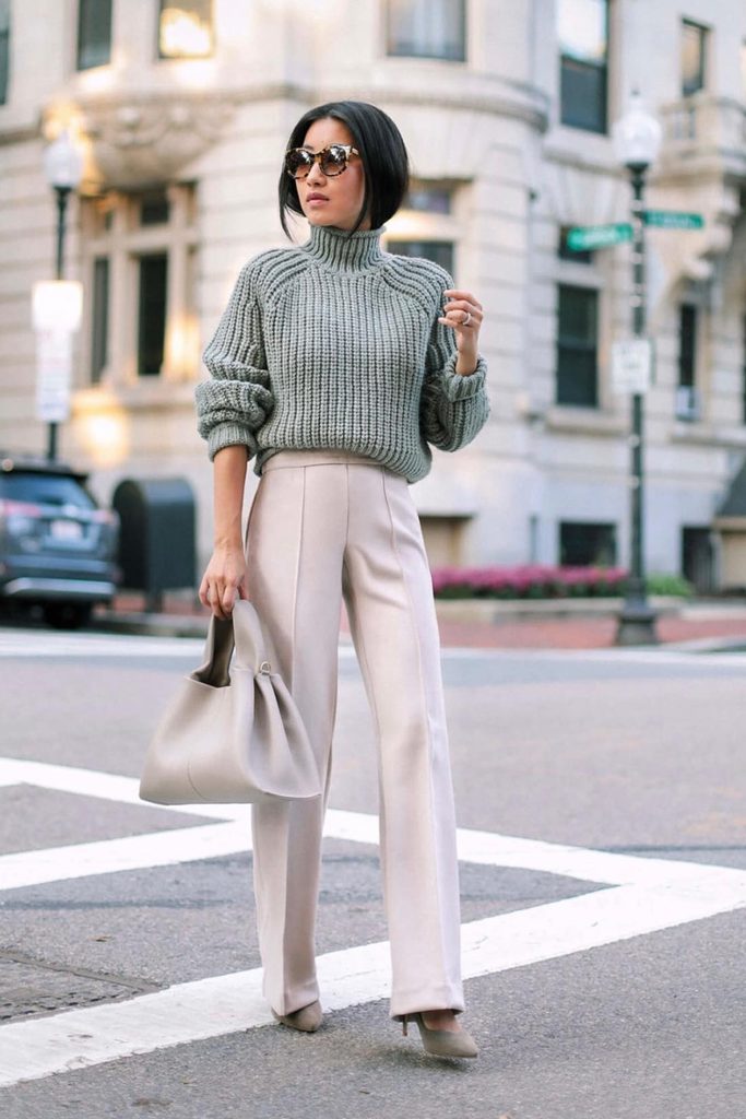 Sage green chunky turtleneck sweater styled with cream trousers, a fresh take on fall outfits for women