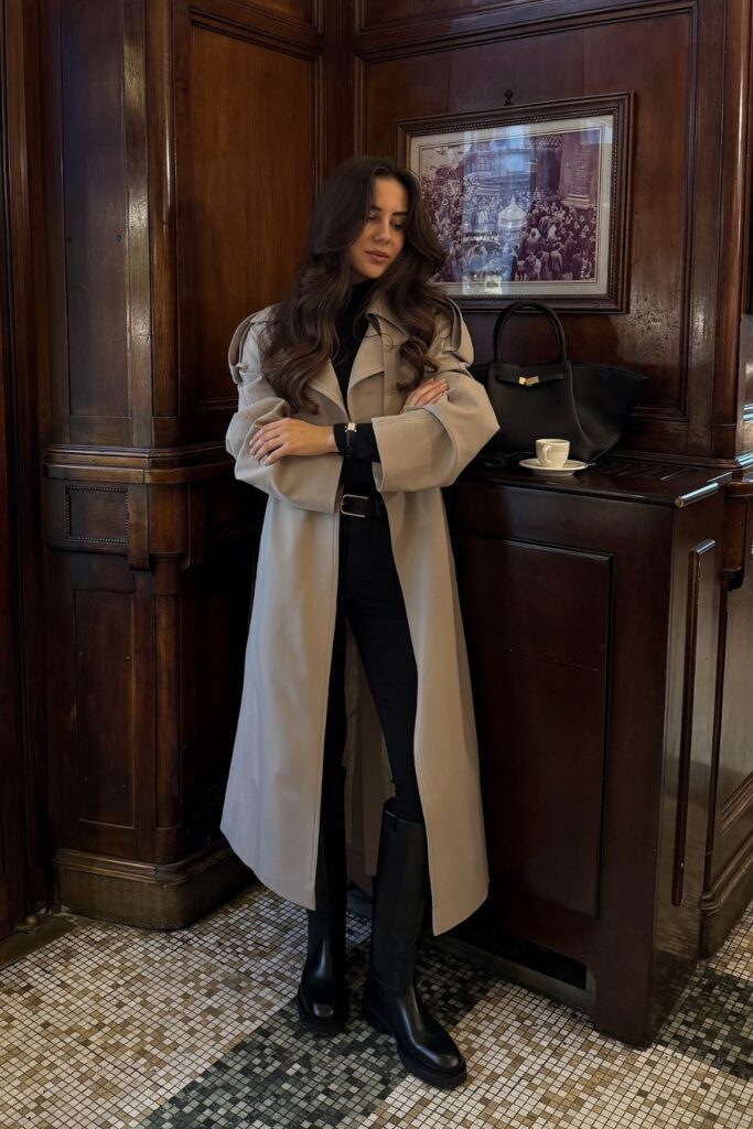 Belted trench coat with black trousers and knee-high boots, a fall fashion outfits idea