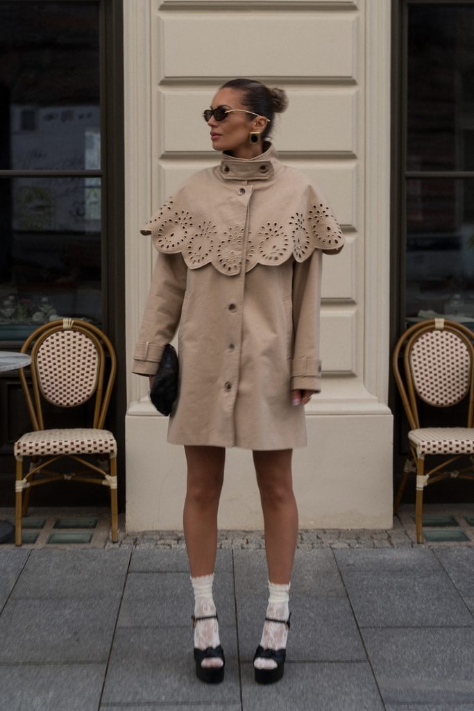 Cream statement coat with eyelet collar, lace socks, and platform heels