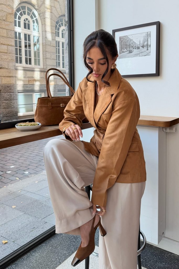 Caramel suede blazer with cream wide-leg trousers, dressed up for a fall evening out