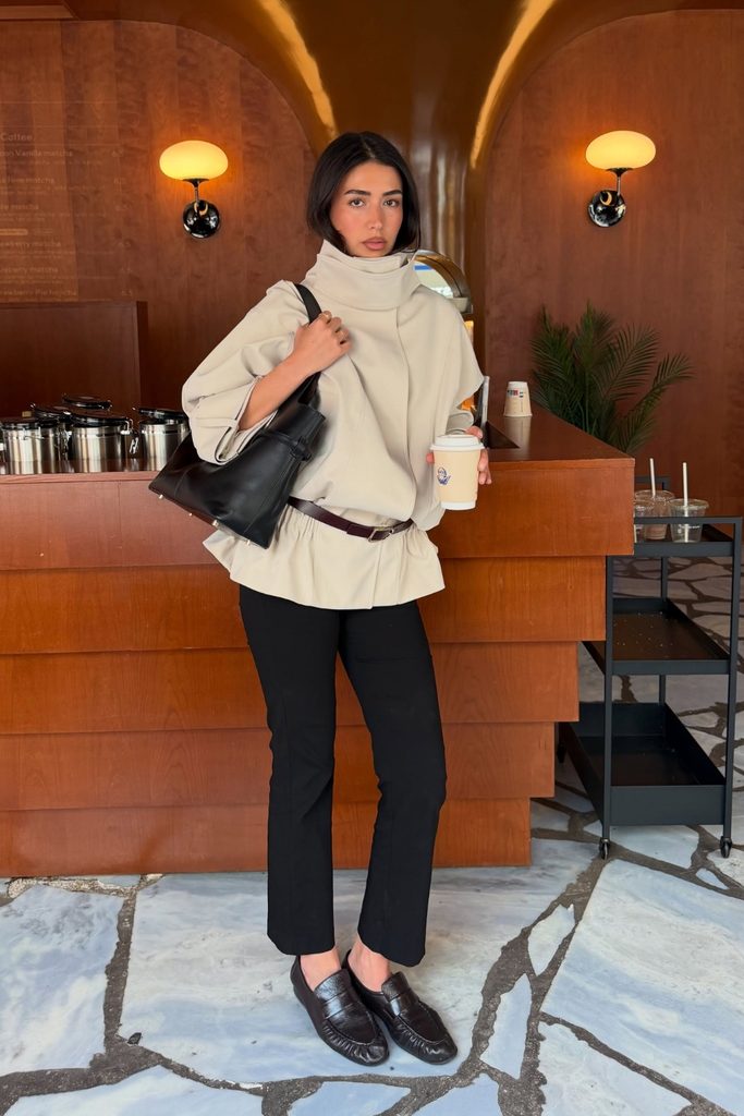 Sculptural cowl neck jacket with black trousers and loafers