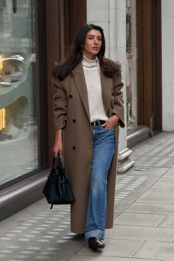 Long taupe coat with cream turtleneck and flared jeans, a classic autumn outfit