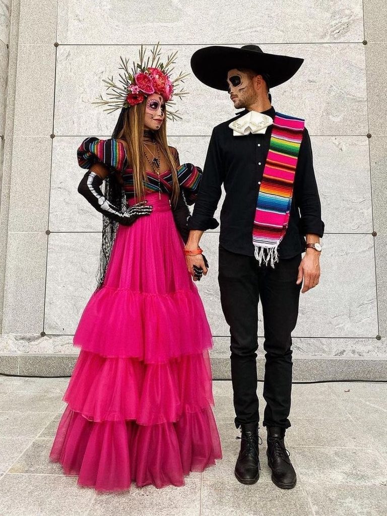 Couple wearing Día de los Muertos-inspired Catrina makeup and a floral crown.