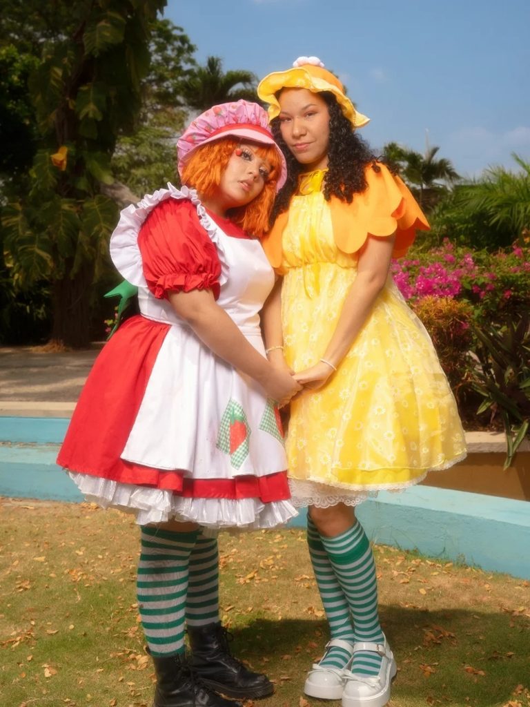 Two friends dressed as Strawberry Shortcake and Lemon Meringue in pastel dresses.