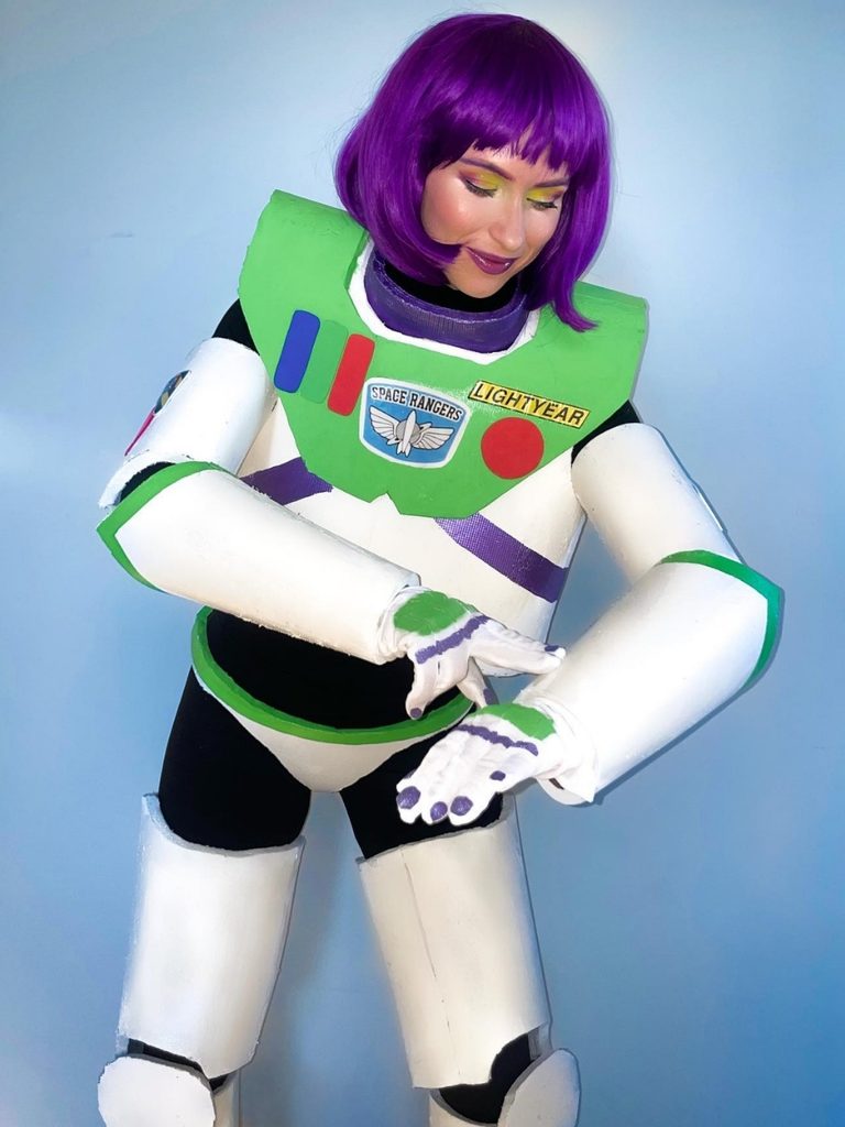 Woman wearing handmade white, green, and purple space ranger armor inspired by Buzz Lightyear.