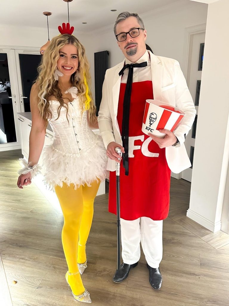 Couple dressed as a fried chicken mascot and a glamorous chicken.