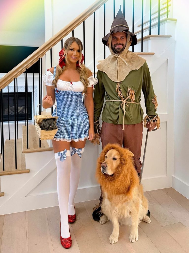 Group dressed as Dorothy, the Scarecrow, and the Cowardly Lion, including a golden retriever.