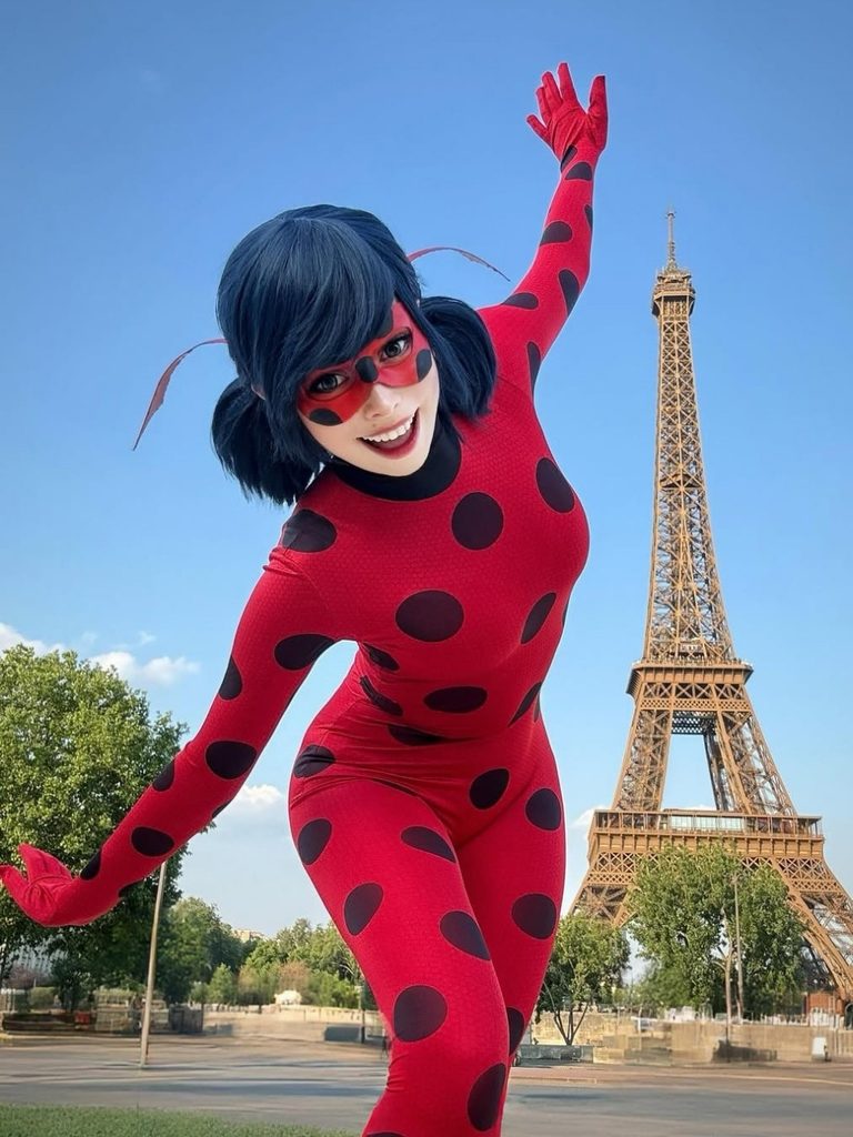 Woman wearing a red polka-dot superhero bodysuit and matching mask inspired by Miraculous Ladybug.