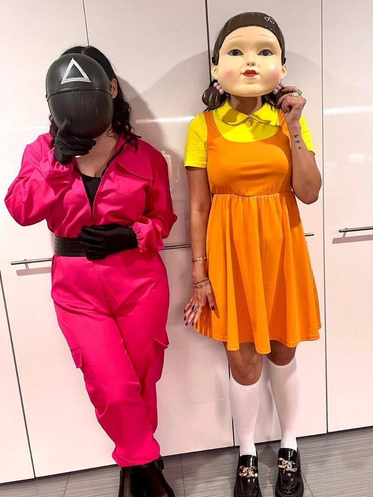 Duo dressed as the pink guard and giant doll from Squid Game.