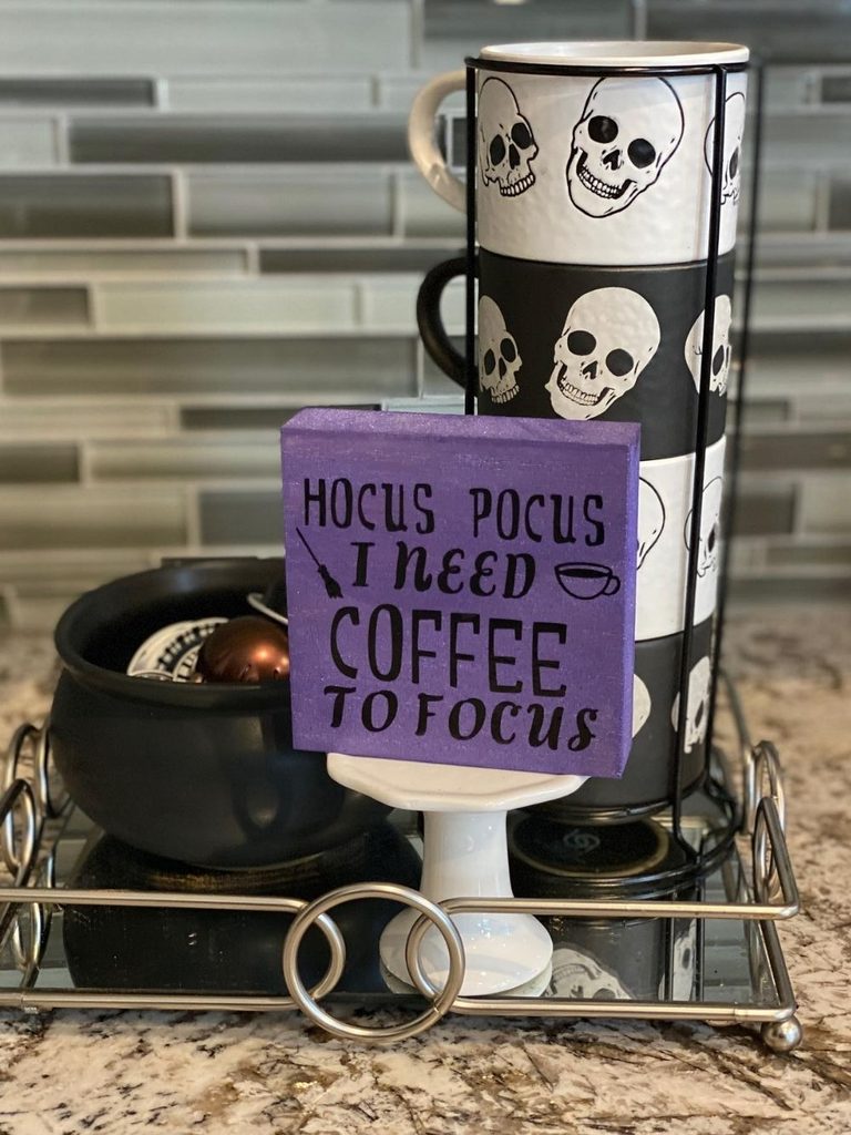 Kitchen coffee corner with skull mugs and a Halloween sign