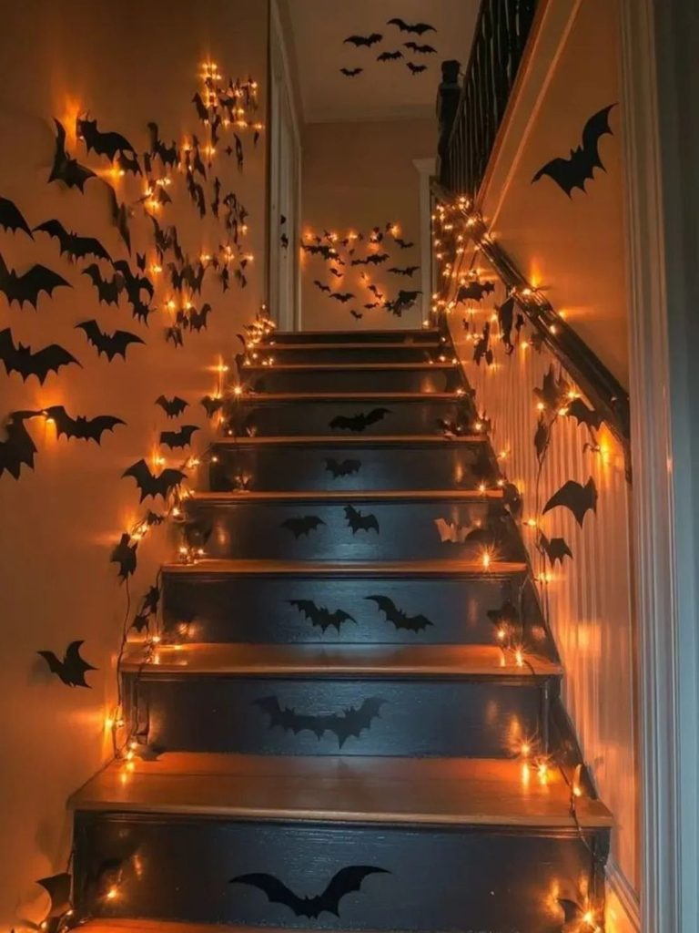 Easy Halloween decorations with paper bats covering a staircase wall