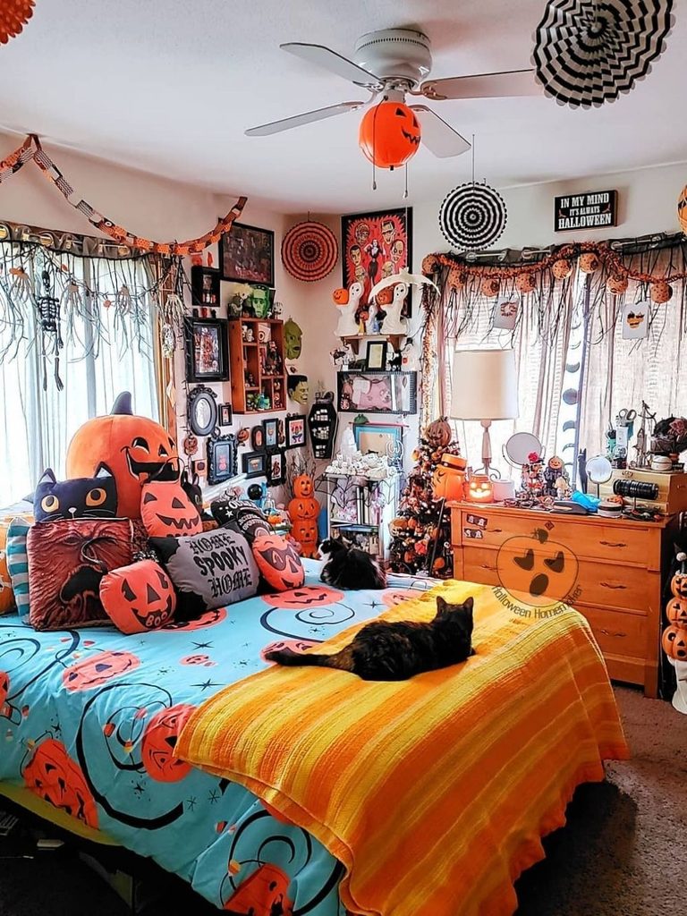Vintage Halloween room decor with collectibles and a jack-o’-lantern light fixture