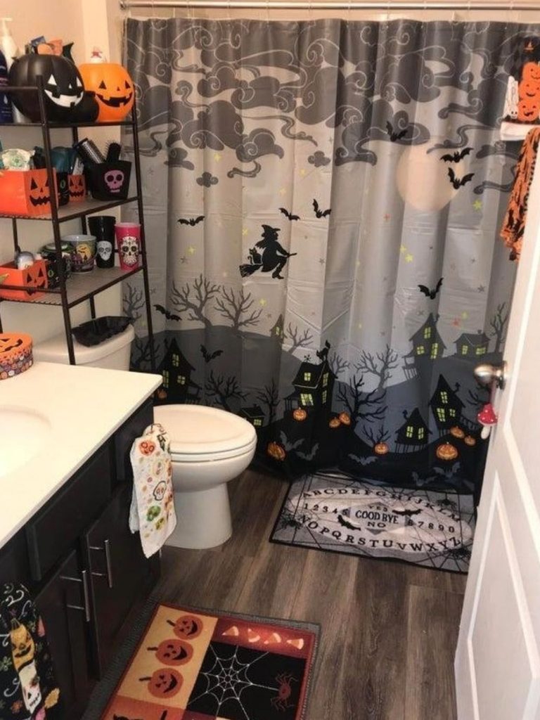 Bathroom with a haunted-village shower curtain and Ouija board bath mat