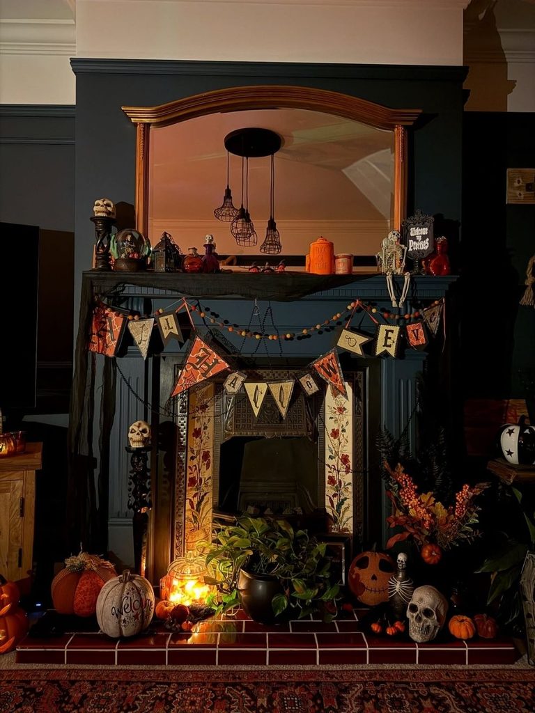 Vintage Halloween decor with a hand-lettered banner and curiosities on a fireplace mantel