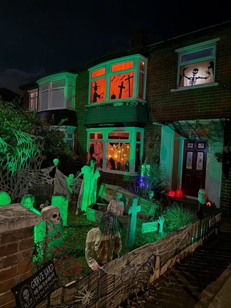 Glowing green graveyard with zombies emerging from the ground