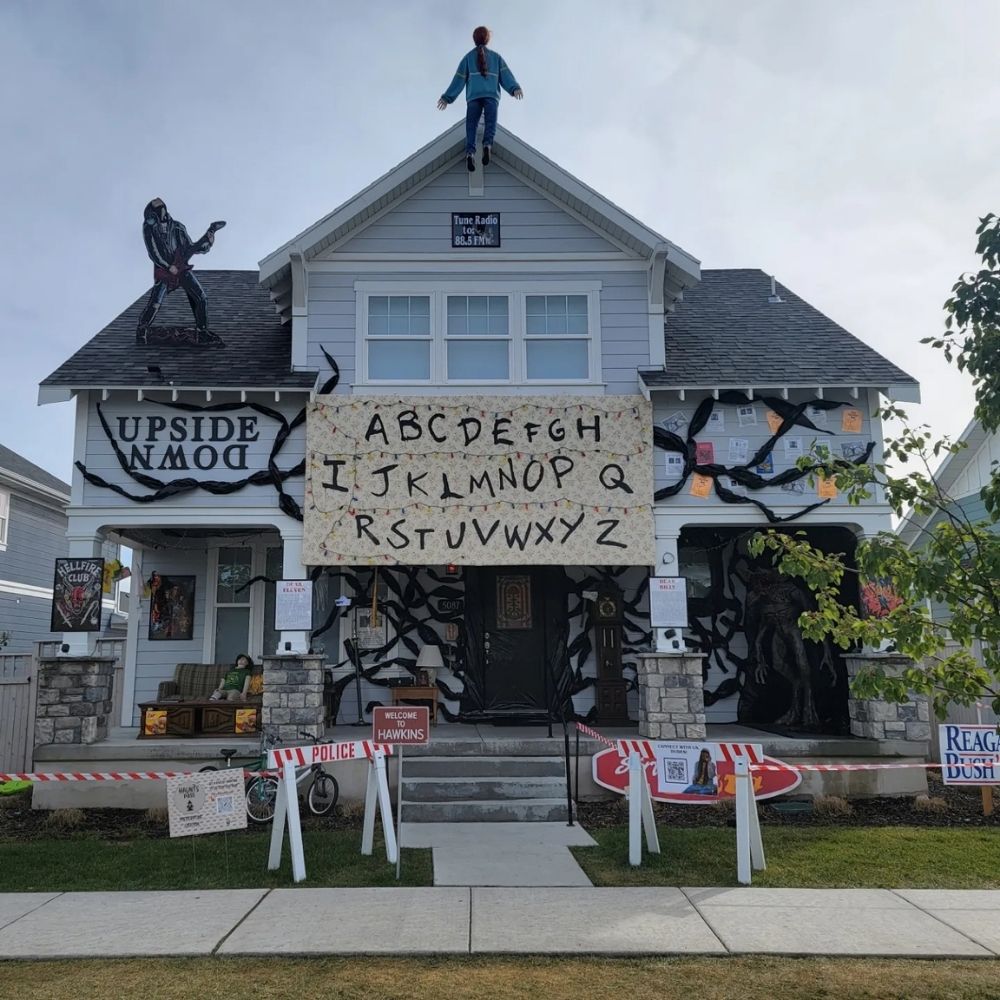 Stranger Things inspired Halloween house decoration with an alphabet light wall and vine-covered porch