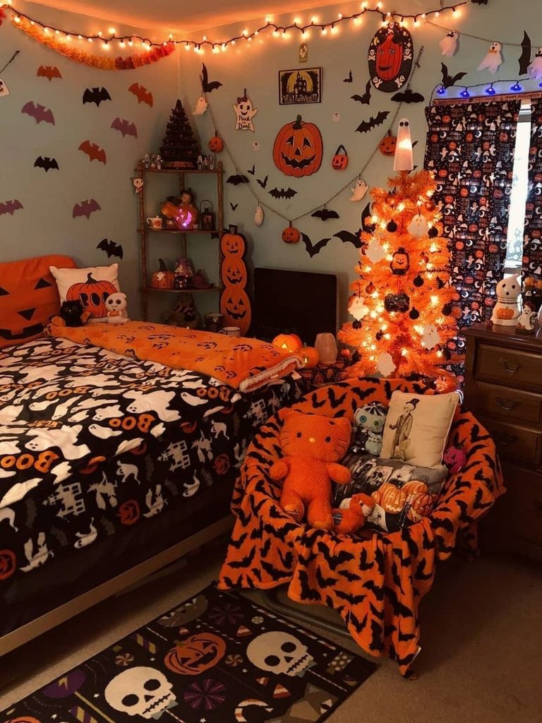 Bedroom with an orange Halloween tree, wall decals, and pumpkin ceiling fan cover