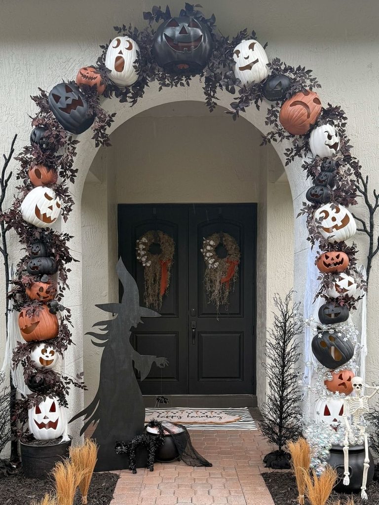 Front entrance with a pumpkin archway and witch silhouette