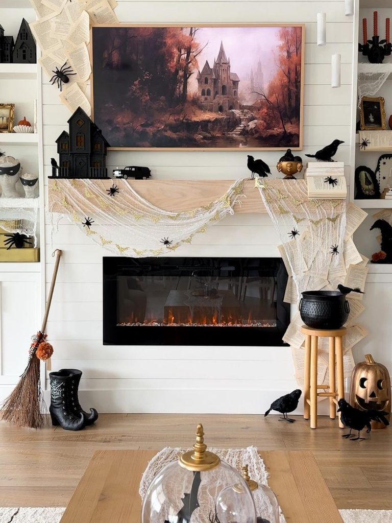 Halloween mantel decor with fanned book pages and dripping candles