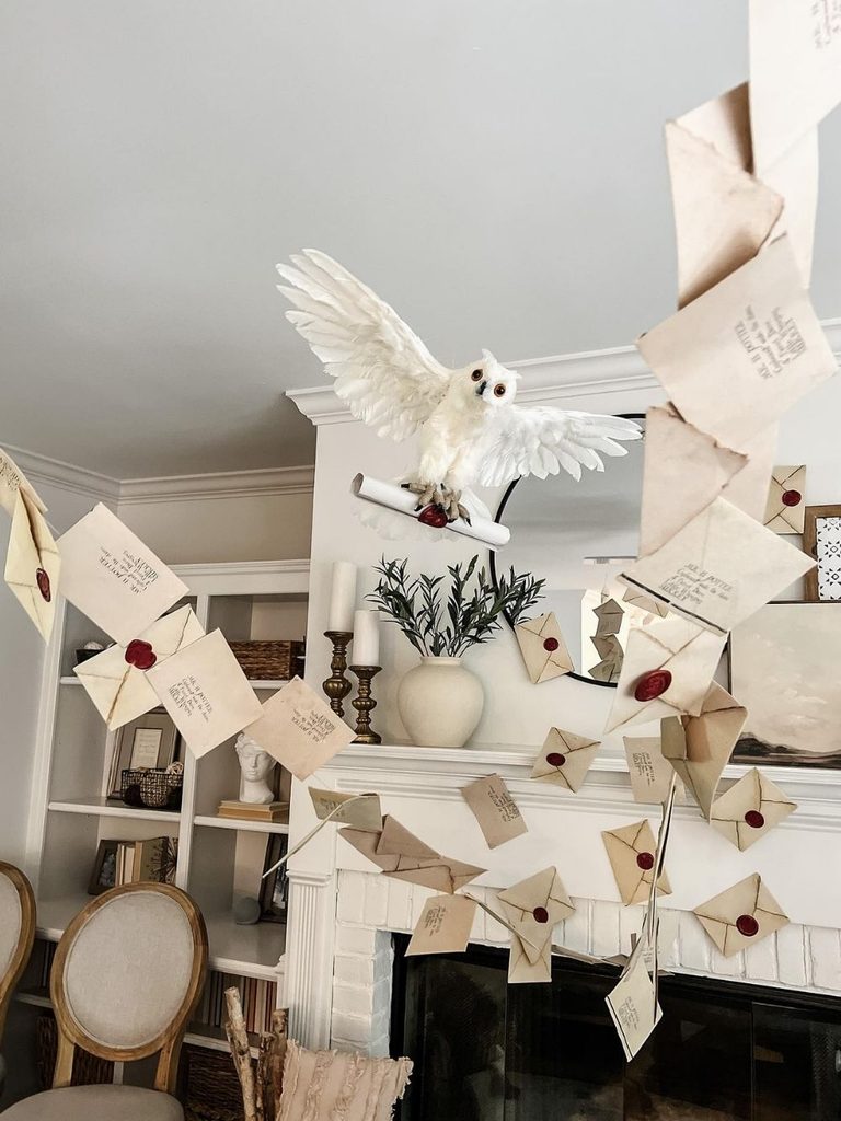 Harry Potter-inspired Halloween decor with an owl and sealed letters on a mantel