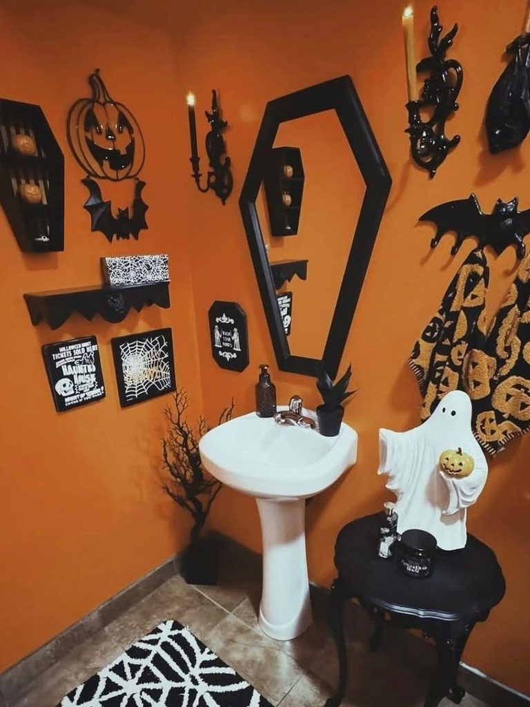 Halloween bathroom decor with a coffin-shaped mirror and matching shelves