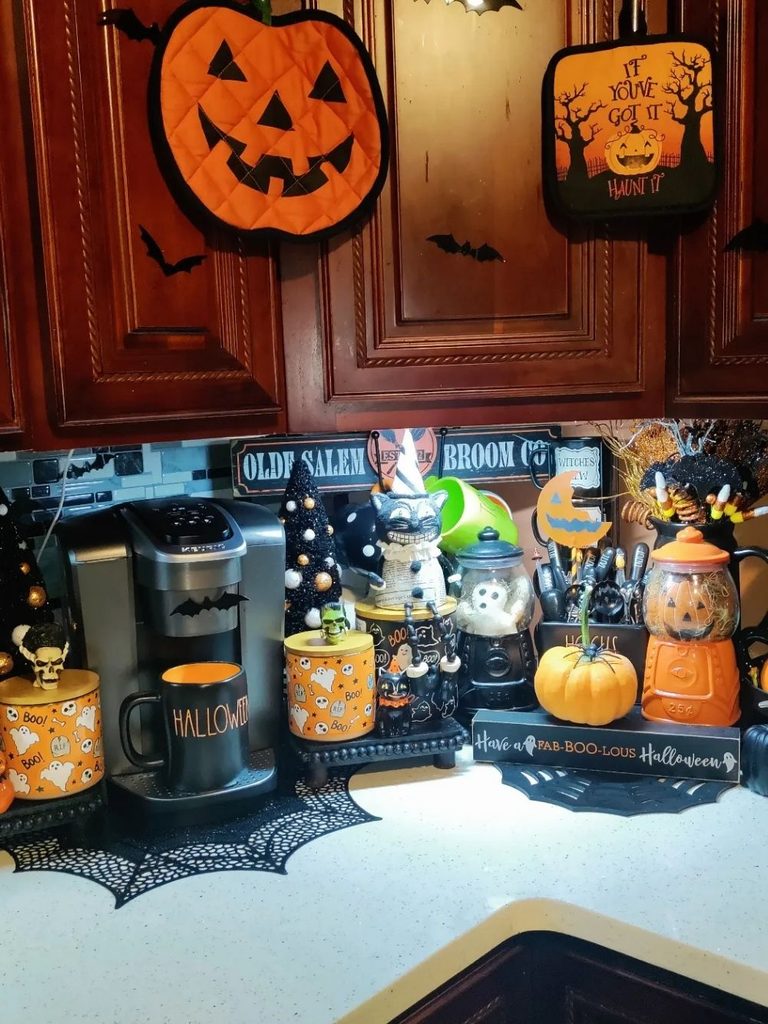 Halloween coffee station decorated with candy corn and a haunted house sign