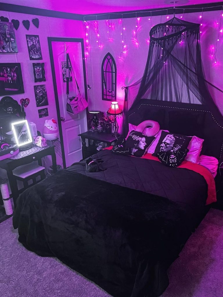 Gothic Halloween room decor with a black canopy bed and pink lighting