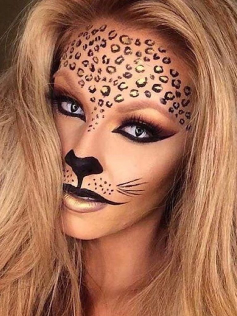 Rosette-shaped spots, bronzed eyeshadow, and a painted nose with whiskers create a fierce leopard makeup look.
