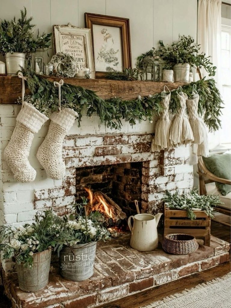 Whitewashed brick fireplace with a wood mantel, olive garland, and cream stockings for simple Christmas decor