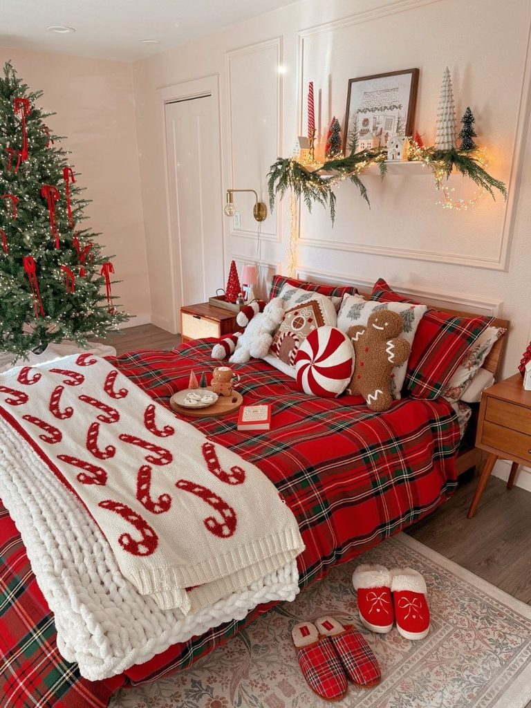 Bedroom with red plaid bedding, a candy cane throw, a peppermint pillow, and matching plaid slippers
