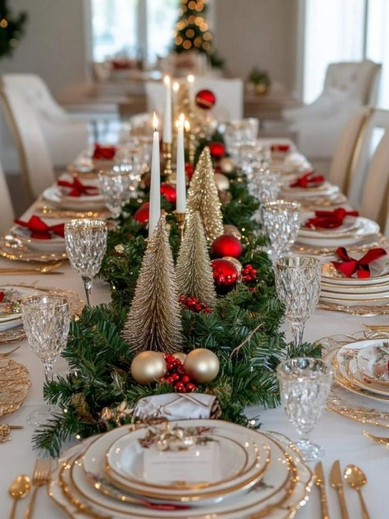 Elegant Christmas dining table decor with gold chargers, a greenery runner, and mini gold trees
