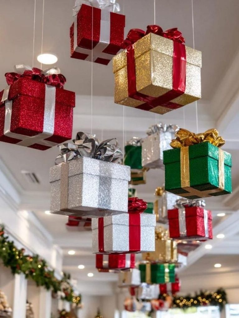 Glittery red, gold, and silver gift boxes hanging from the ceiling, one of the most surprising Christmas decor ideas for a living room