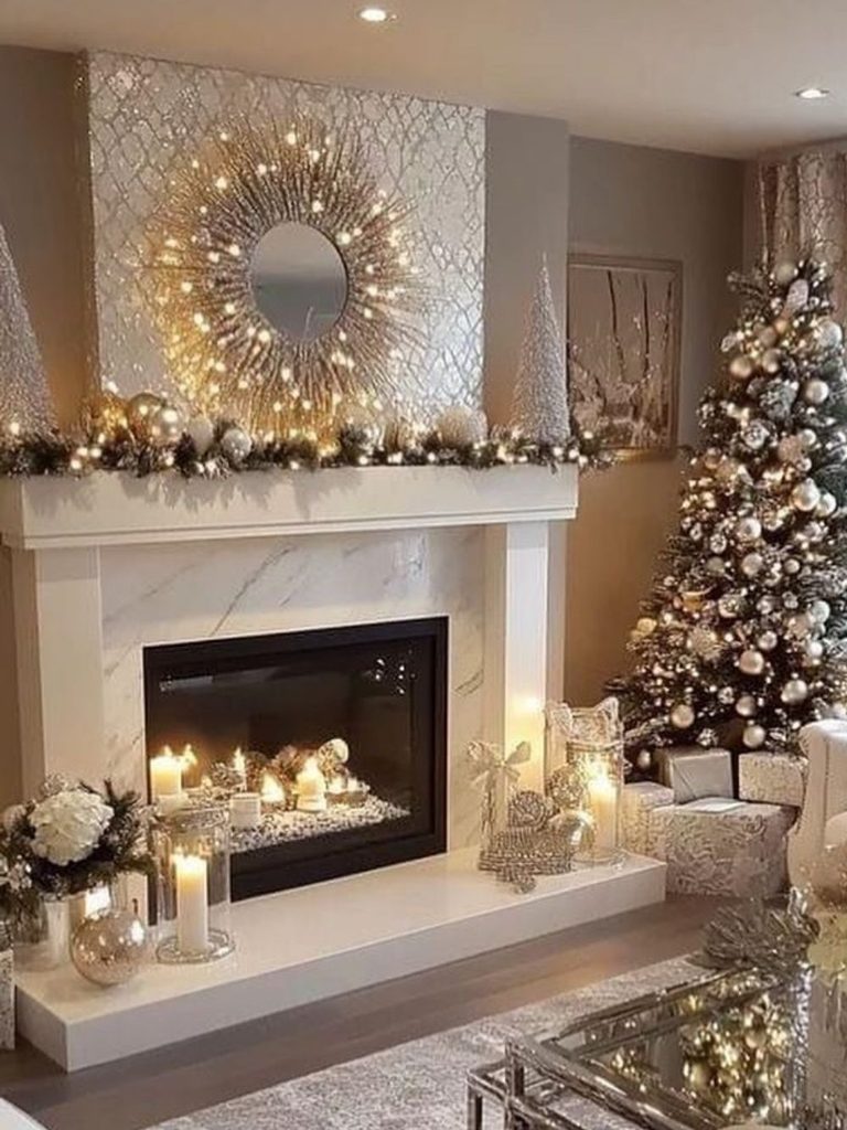 Marble fireplace with lights and candles in the hearth, a flocked tree, and a glass coffee table styled for Christmas