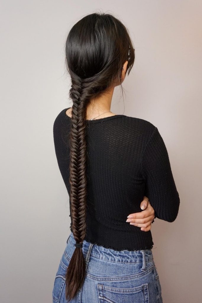 Long dark fishtail braid down the back, one of the best braid hairstyles for long hair