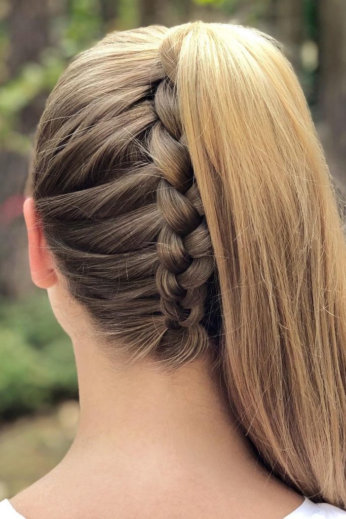 Upside down Dutch braid running along the side of the head into a high ponytail