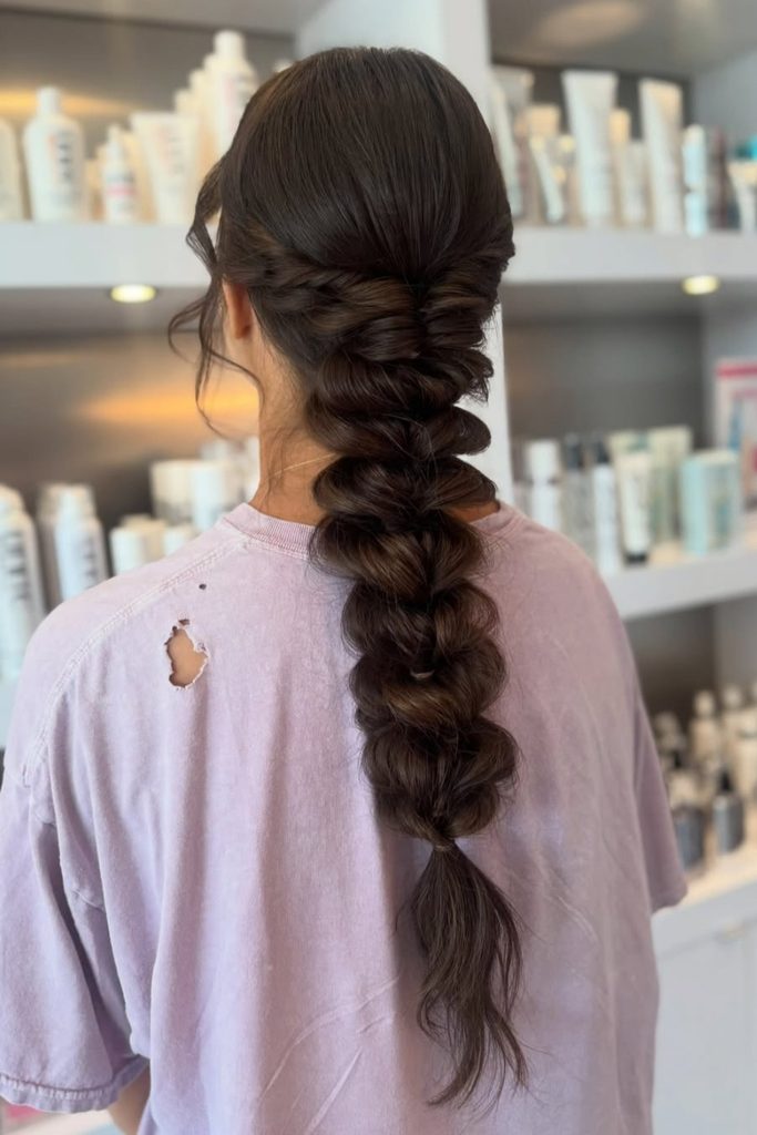 Textured boho fishtail braid hanging over one shoulder