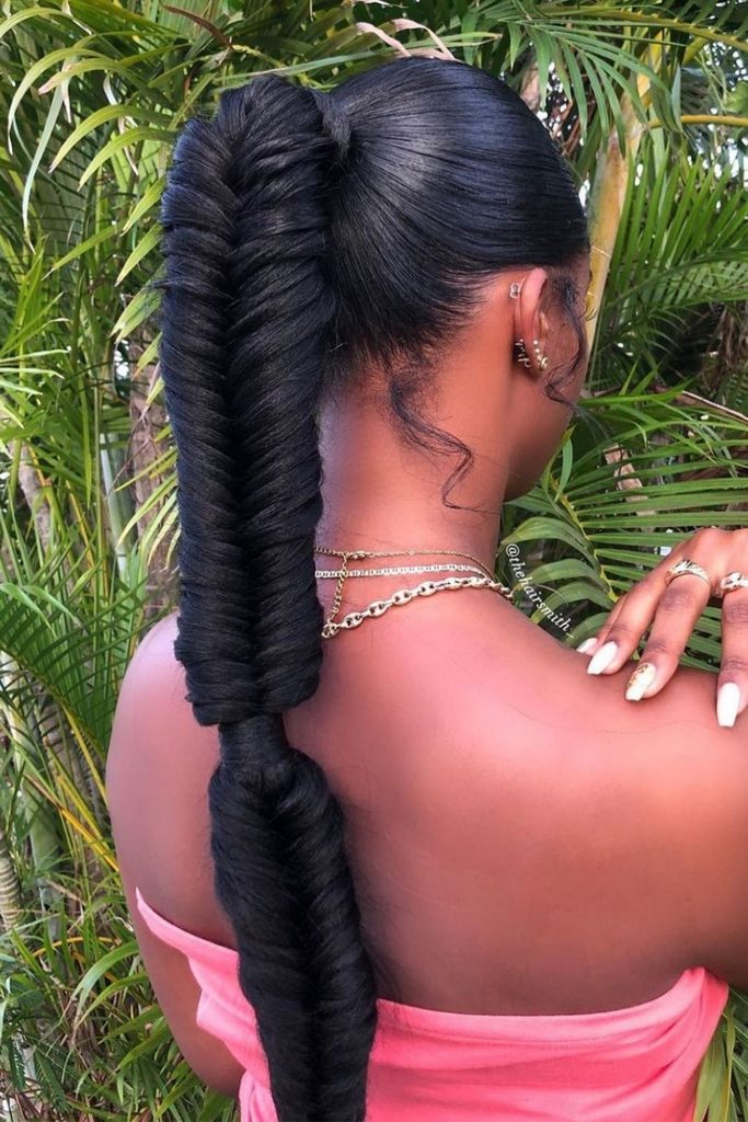 Sleek high ponytail with the full length braided into a glossy fishtail